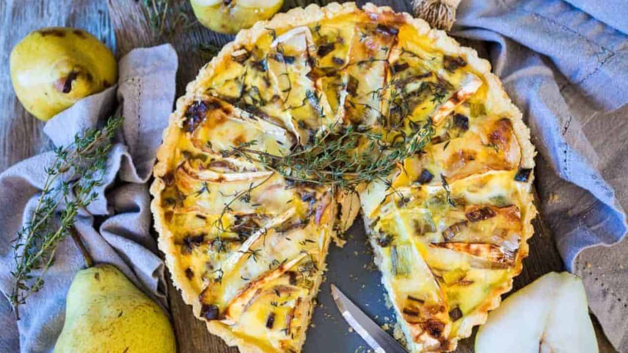 A quiche with pears and sprigs of thyme.