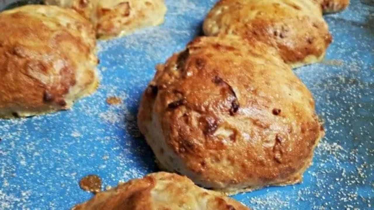 Image shows Goat Cheese and Caramelized Onion Rolls on a blue silpat coated with cornmeal.