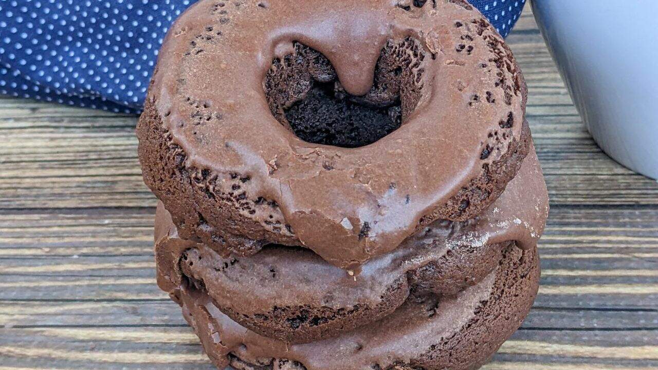 Stack of donuts on a wooden surface.