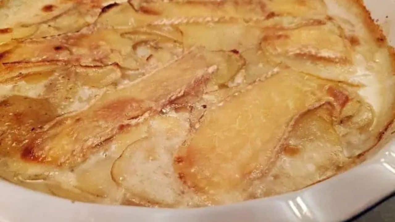 Image shows a closeup of a casserole of Smoked Brie Potato Gratin.