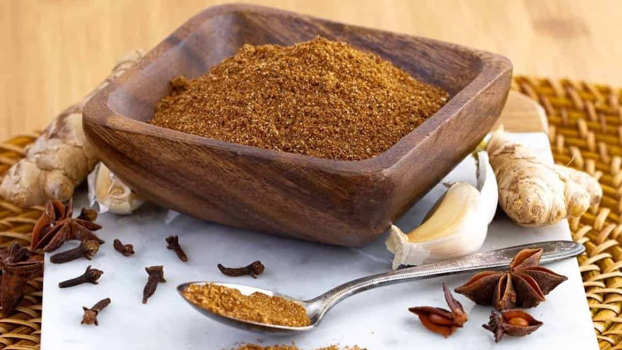 A jar of Thai 7 Spice seasoning blend with a mix of colorful spices.