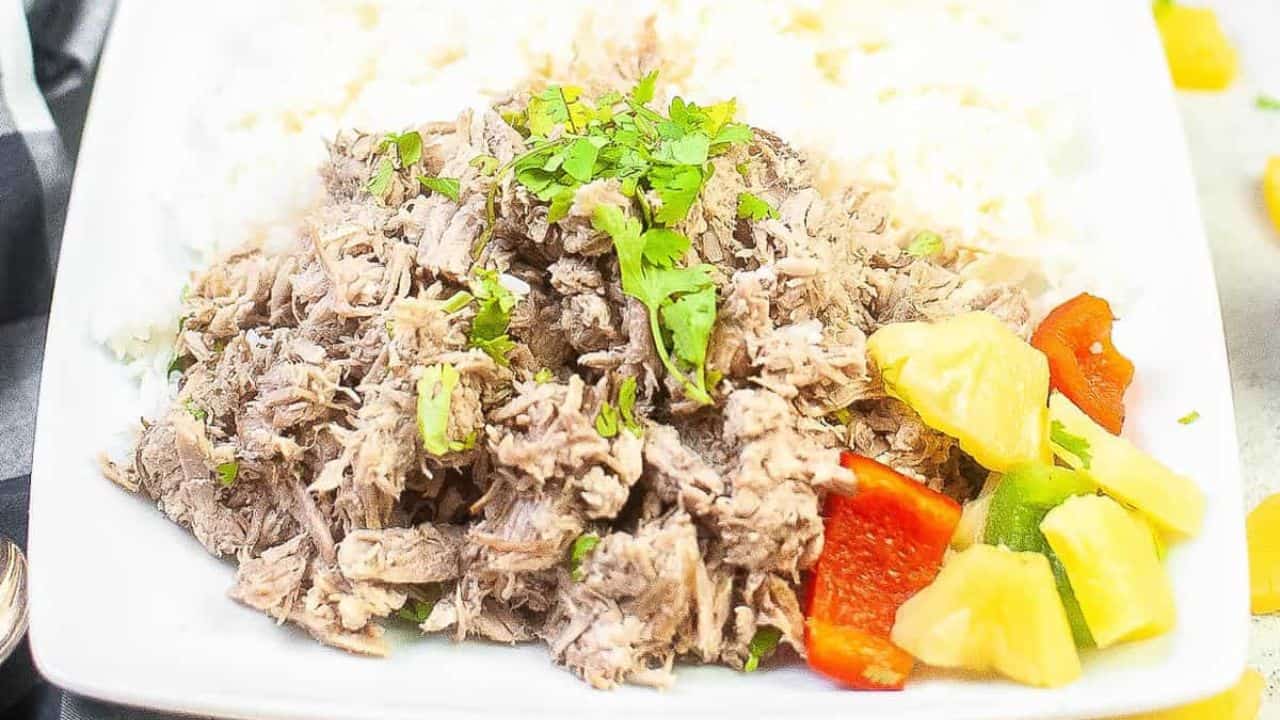 Slices of hot honey pork tenderloin on a cutting board with sauce.