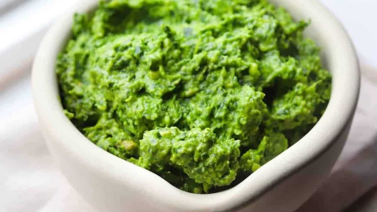 A close-up image of kale pesto sauce in a bowl.