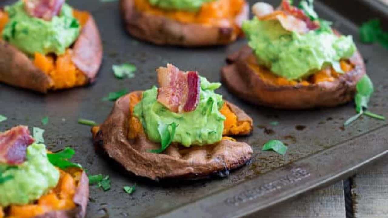 Sweet potato bites topped with guacamole and bacon.