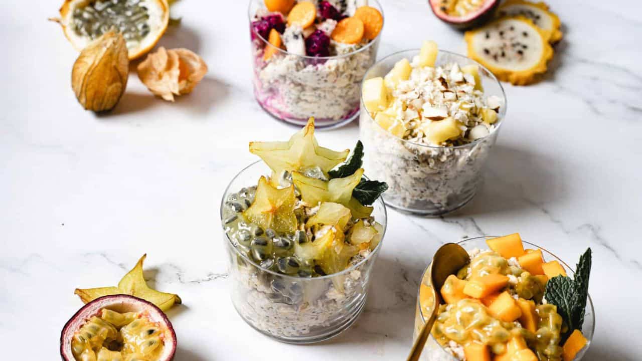 Four combinations of vegan overnight oats with fruit.