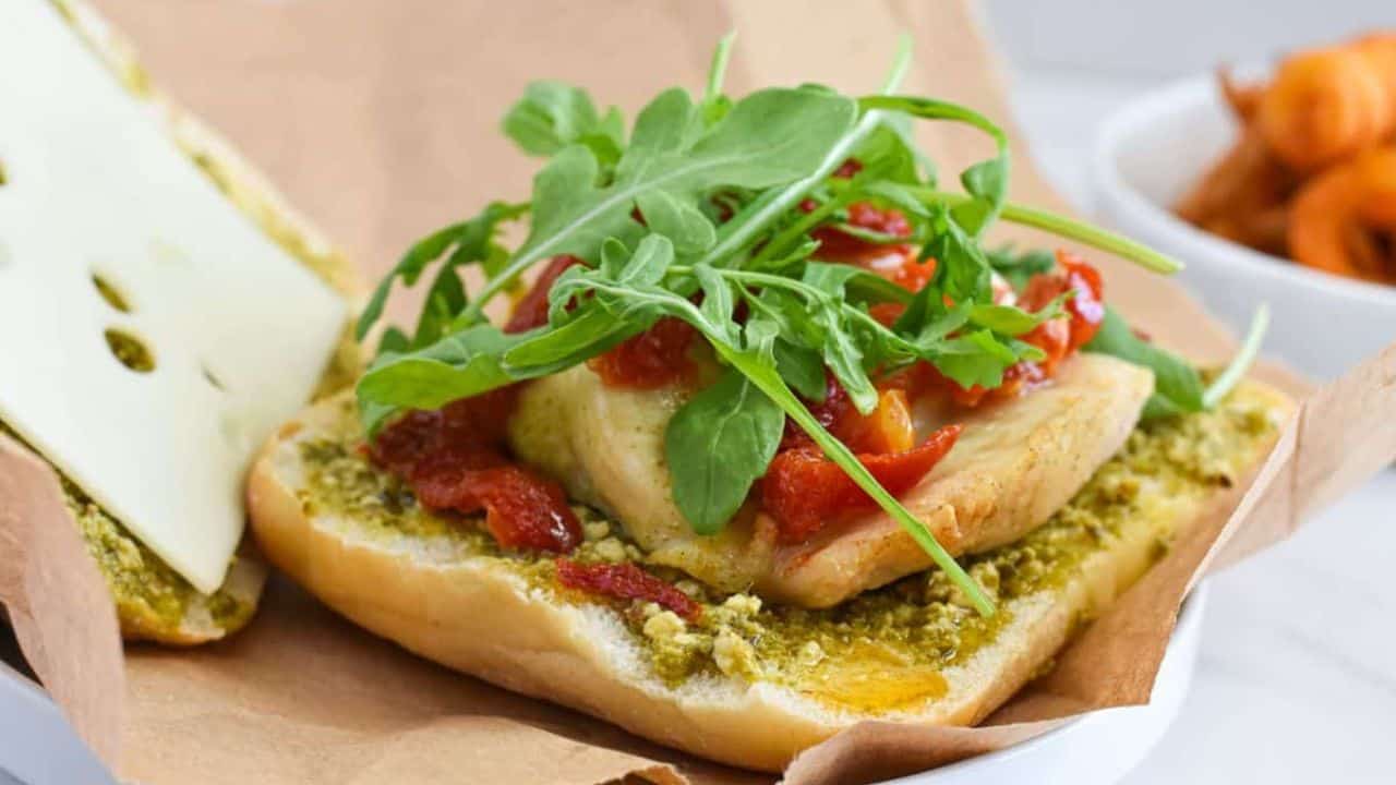 Air fryer chicken pesto sandwich on a white plate.