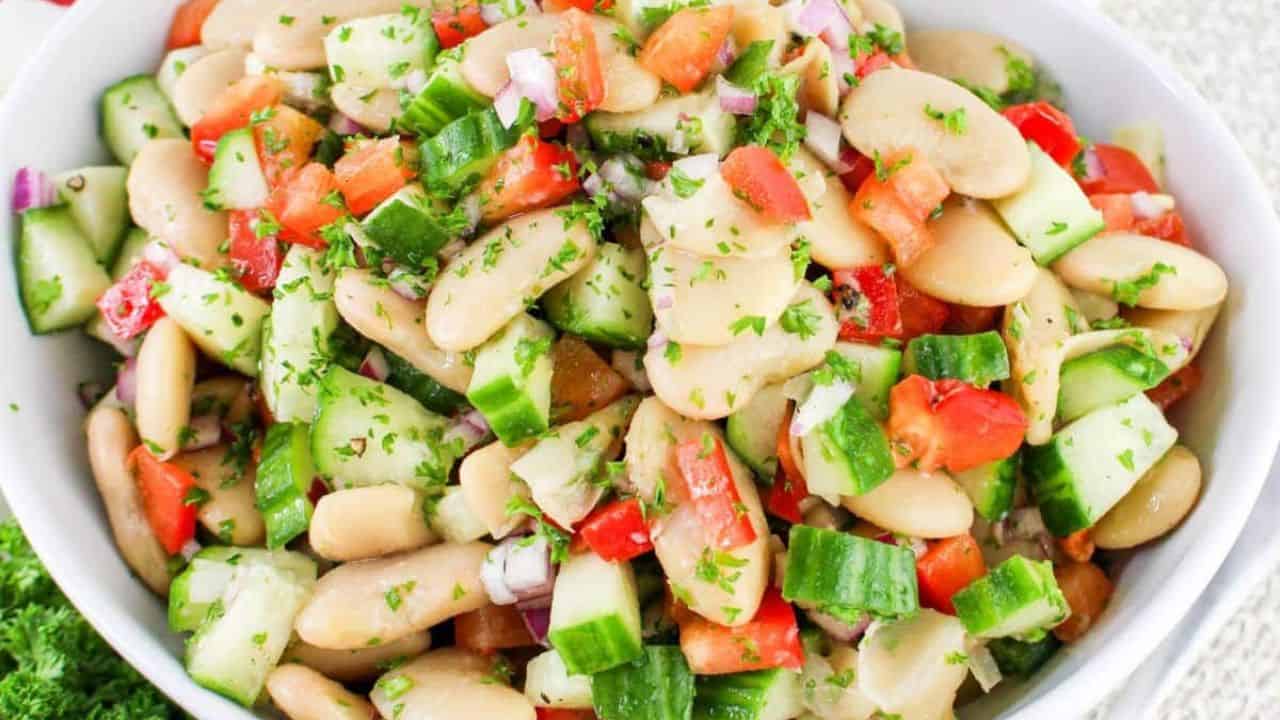 Bowl full of butter bean salad on a table.