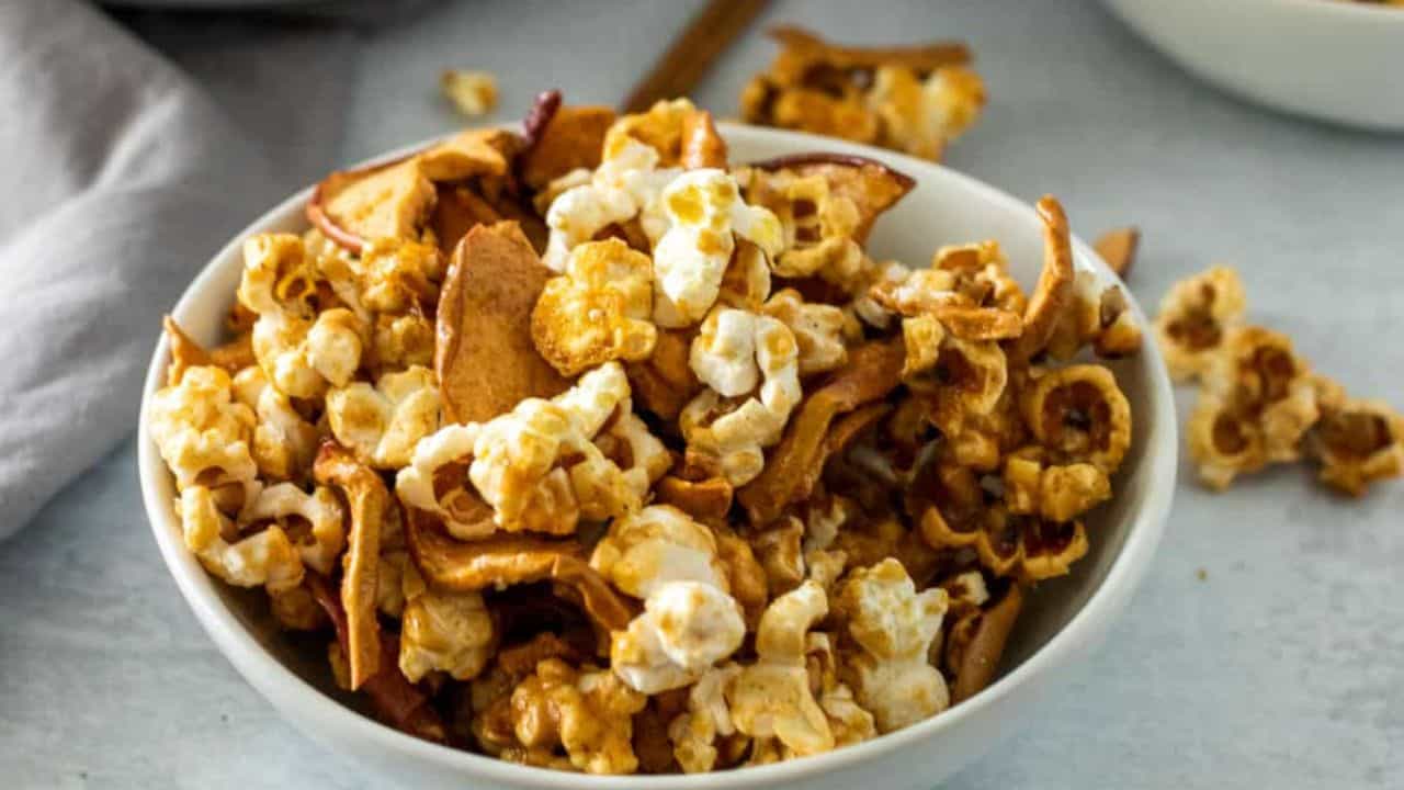 A white bowl with caramel apple popcorn.