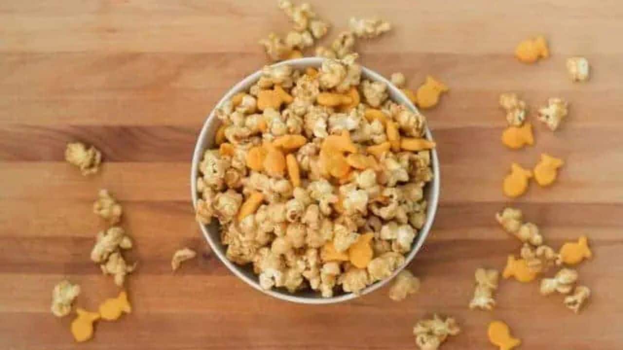 Image shows an overhead shot of Chicago style popcorn mix on a wooden table.