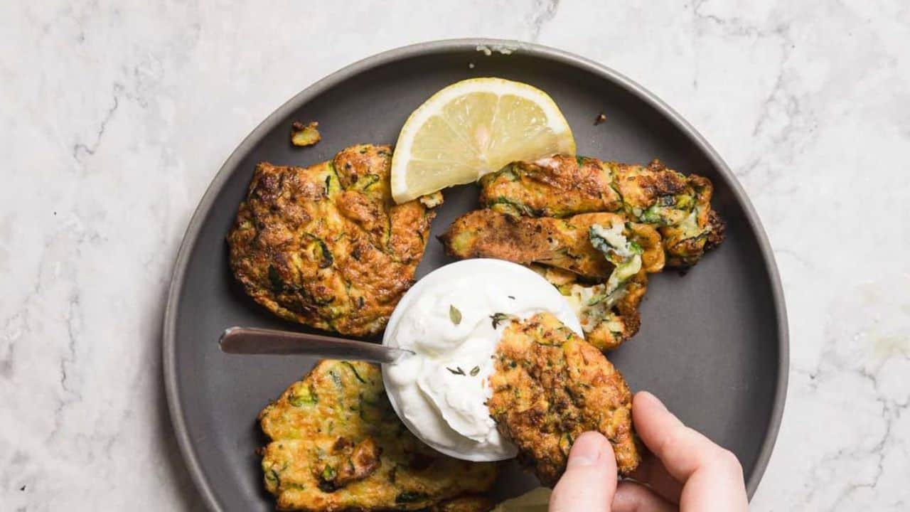 Overhead view of two fritters on plate.