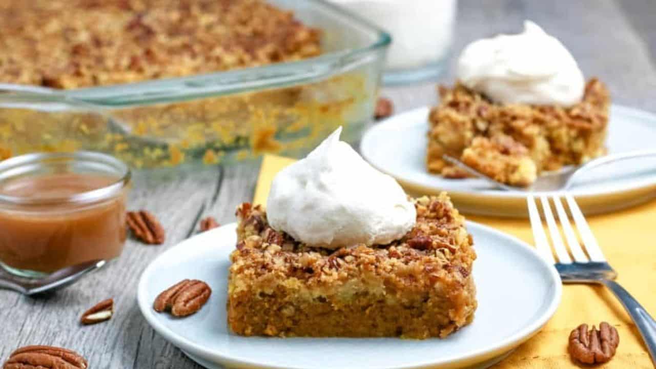Pumpkin Dump Cake on a plate with whipped cream.
