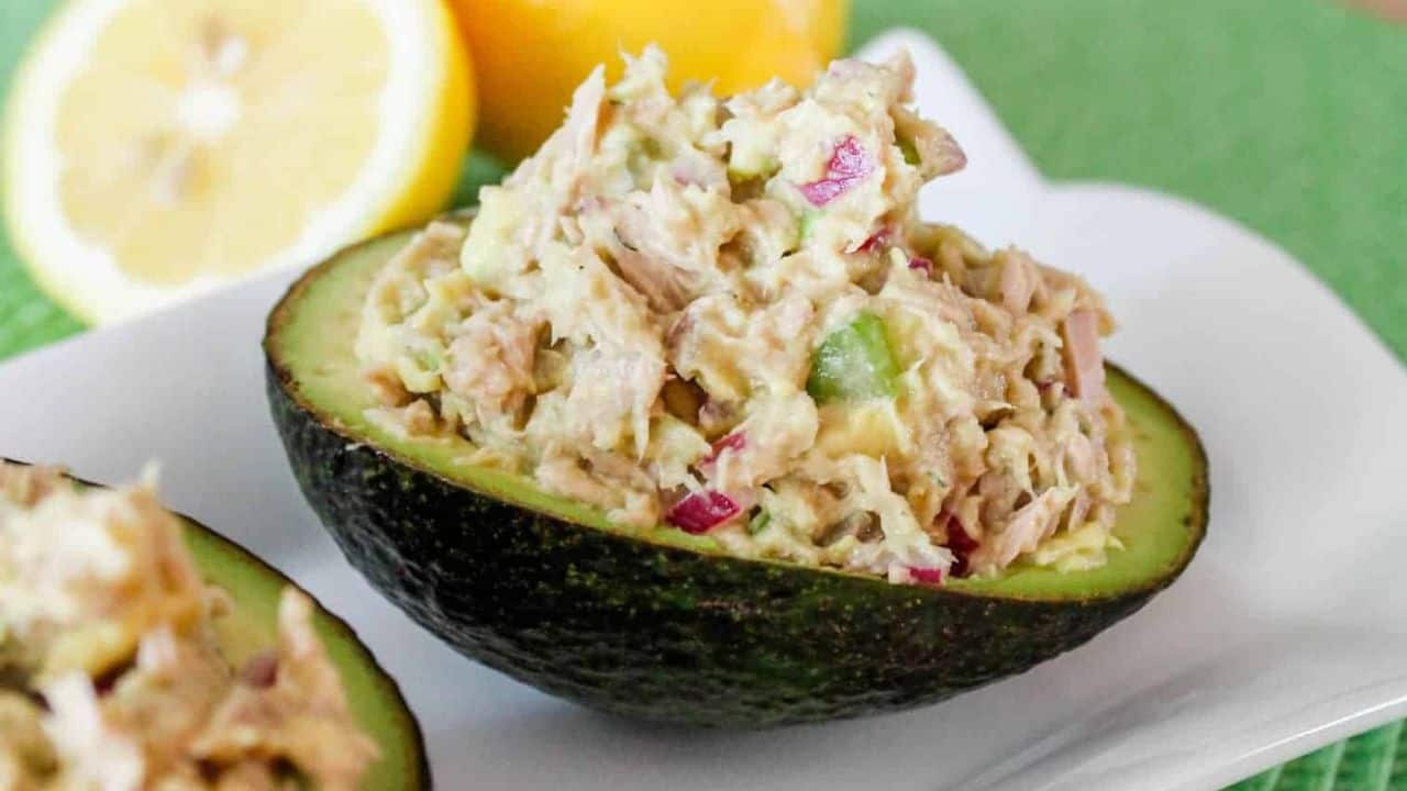 An avocado shell stuffed with avocado tuna salad.