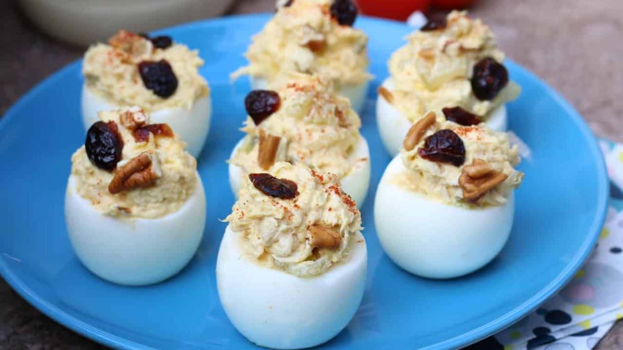 Blue plate with chicken salad deviled eggs.