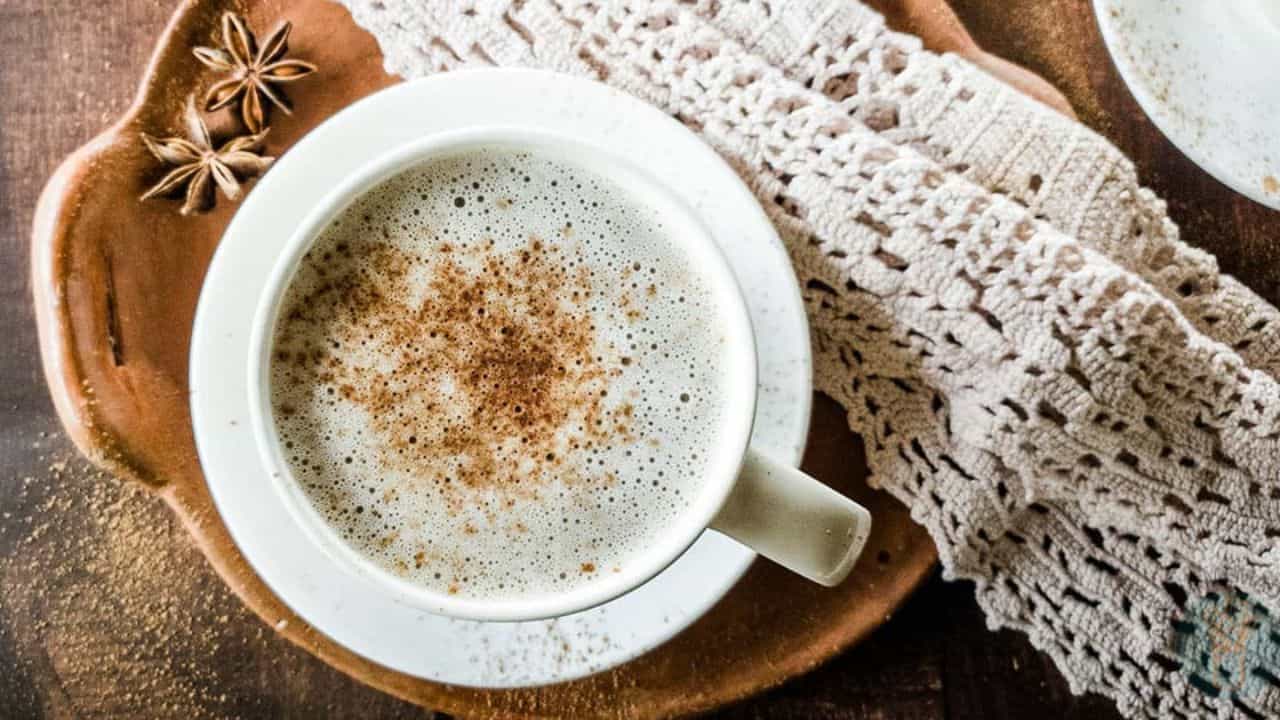 Chocolate Chai Latte in white teacup on clay dish with lace napkin.