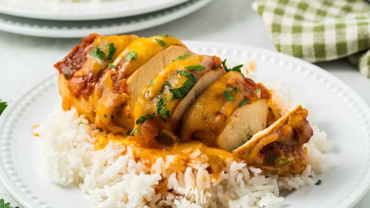 Crockpot Cheesy Salsa Chicken on a plate with rice and sauce.