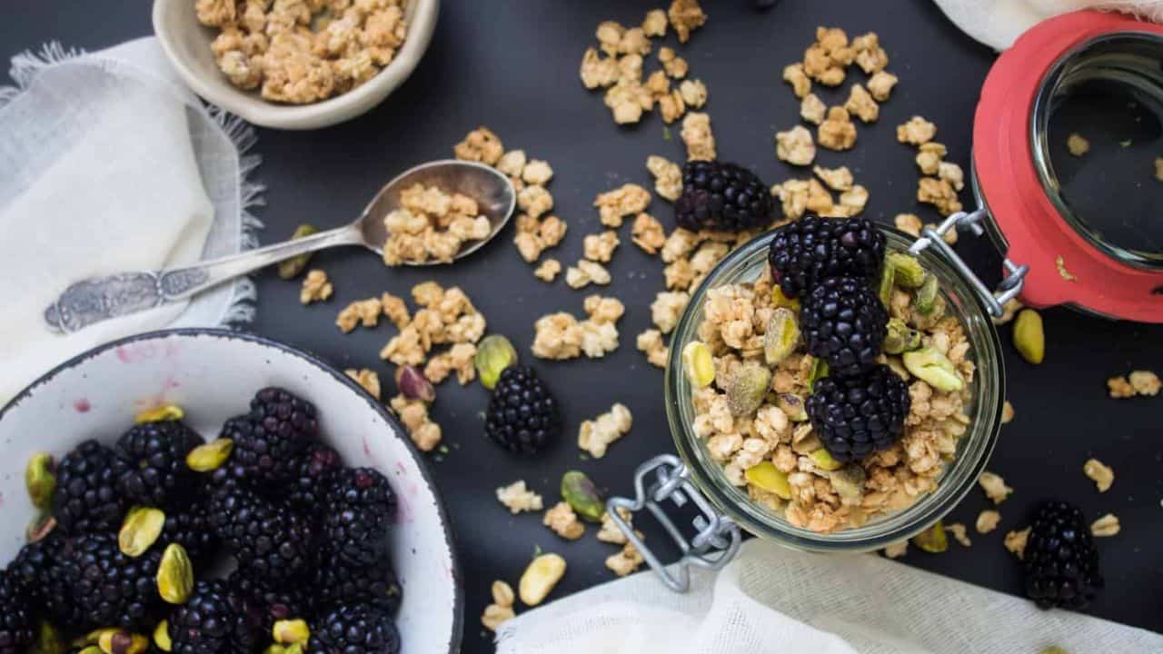 Overhead view of kiwi and blackberry on top of yogurt parfait.