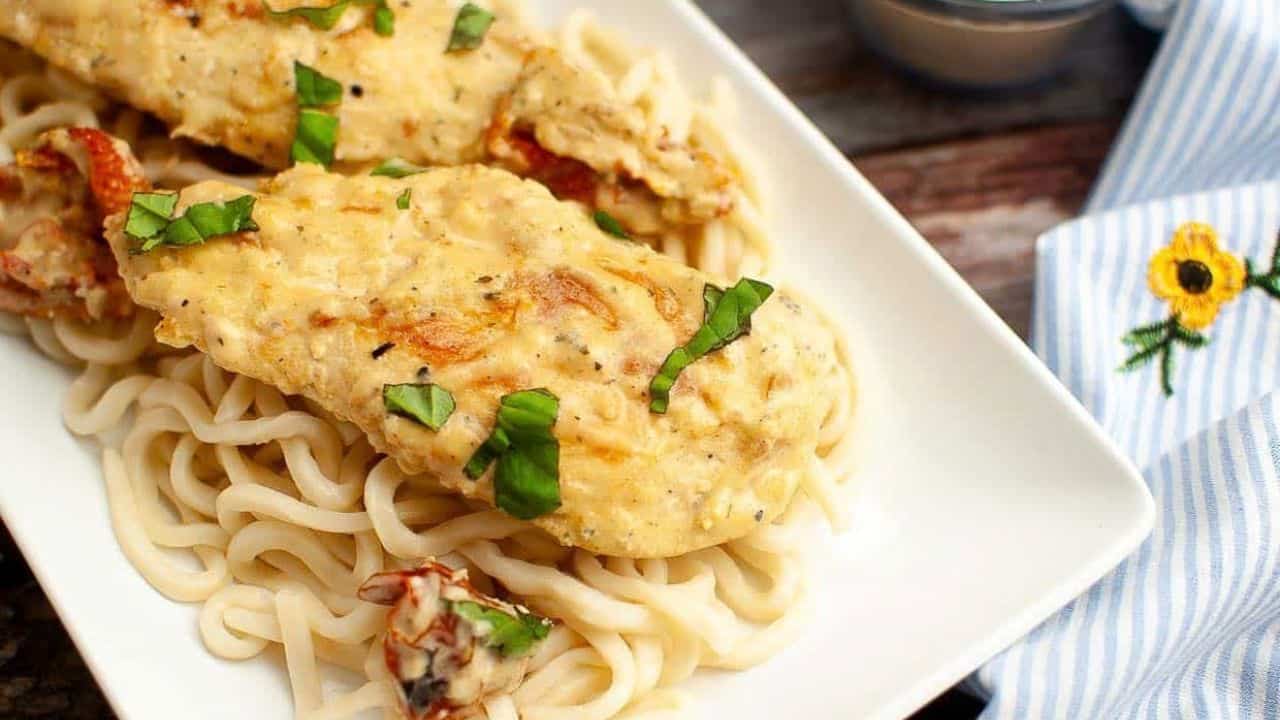 Crock Pot Marry Me Chicken on a plate with pasta.