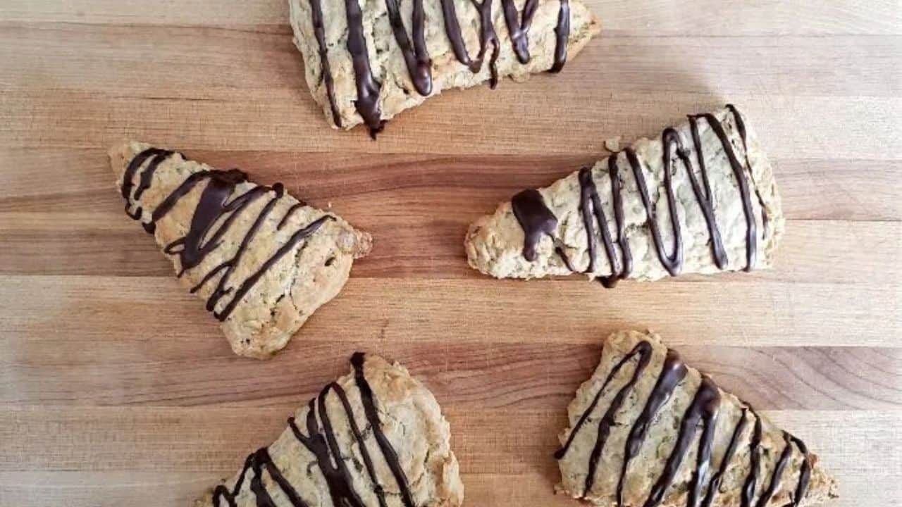 Image shows Chocolate drizzled mocha scones on a cutting board.