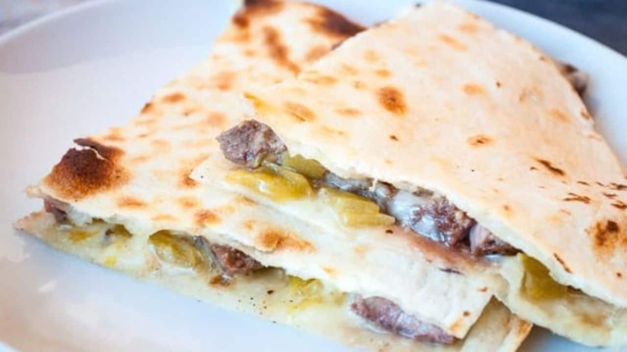 Two pieces of quesadilla stacked on top of each other. 